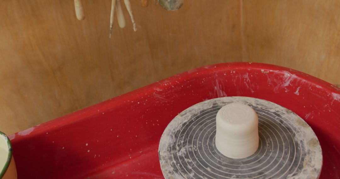 Pottery Wheel with Raw Clay in Artistic Workshop Environment