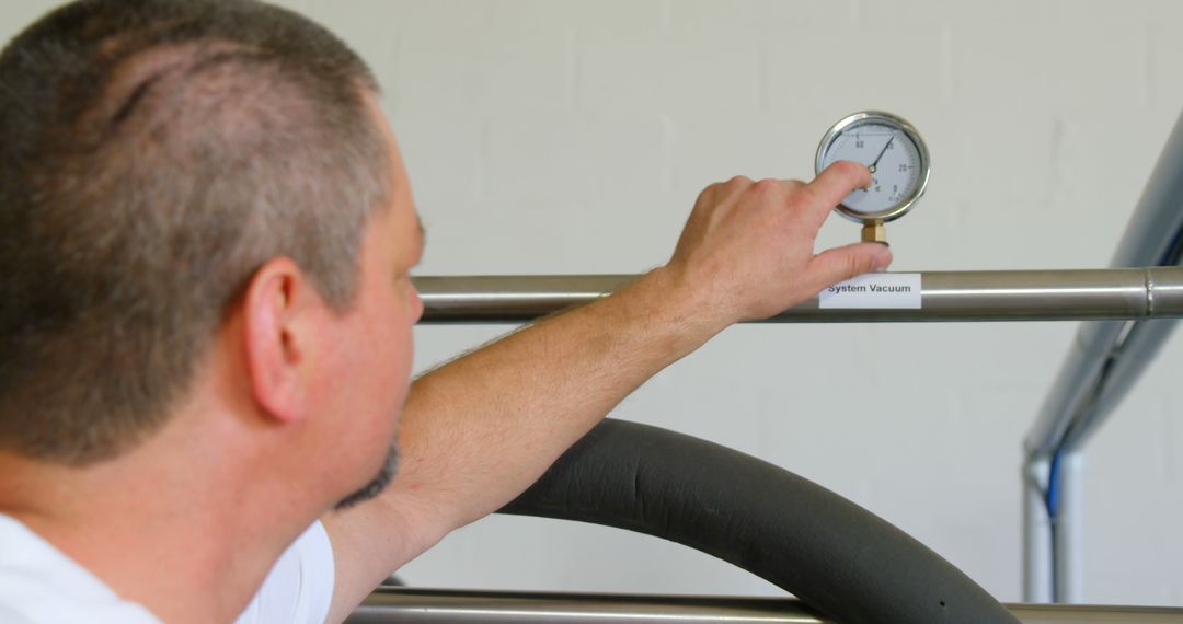 Technician Checking Pressure Gauge on Industrial Machinery - Free Images, Stock Photos and Pictures on Pikwizard.com