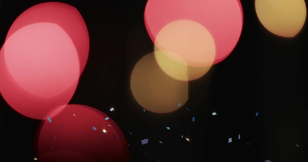 Glowing Festive Lights and Falling Confetti on Dark Background