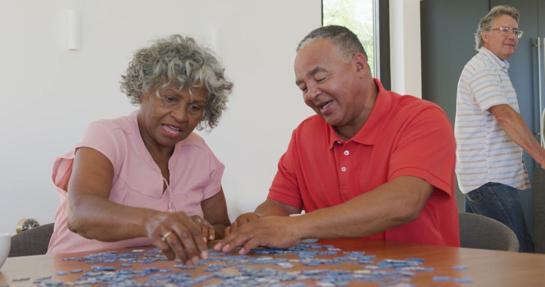 Seniors Engaged in Solving Jigsaw Puzzle Together - Free Images, Stock Photos and Pictures on Pikwizard.com