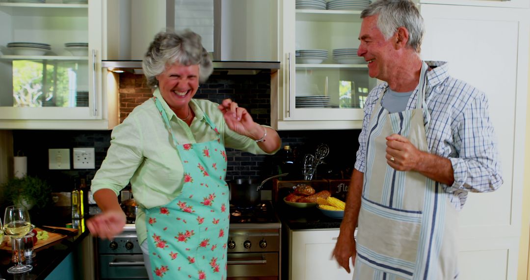 Senior Couple Cooking and Laughing in Modern Kitchen - Free Images, Stock Photos and Pictures on Pikwizard.com