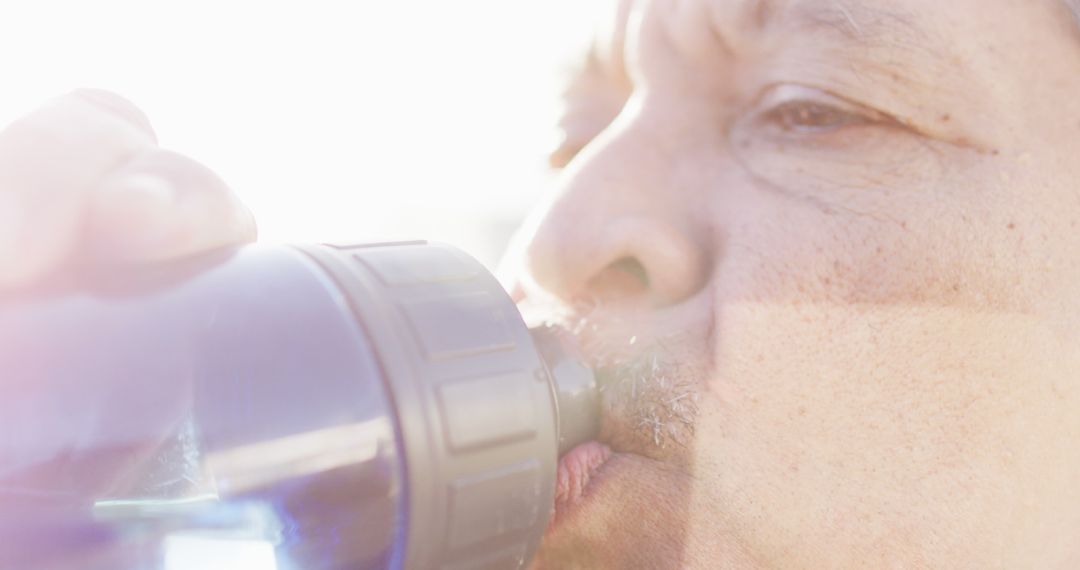 Person Drinking Water from Bottle in Bright Sunlight - Free Images, Stock Photos and Pictures on Pikwizard.com