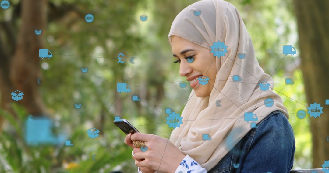 Woman in Hijab Interacting Online Using Smartphone in Park