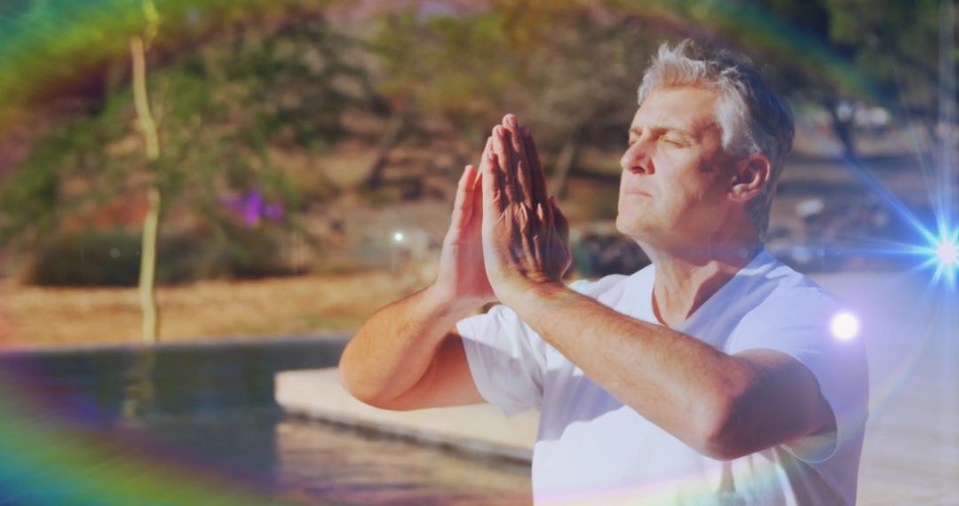 Serene Mature Man Meditating by Pool with Lens Flare