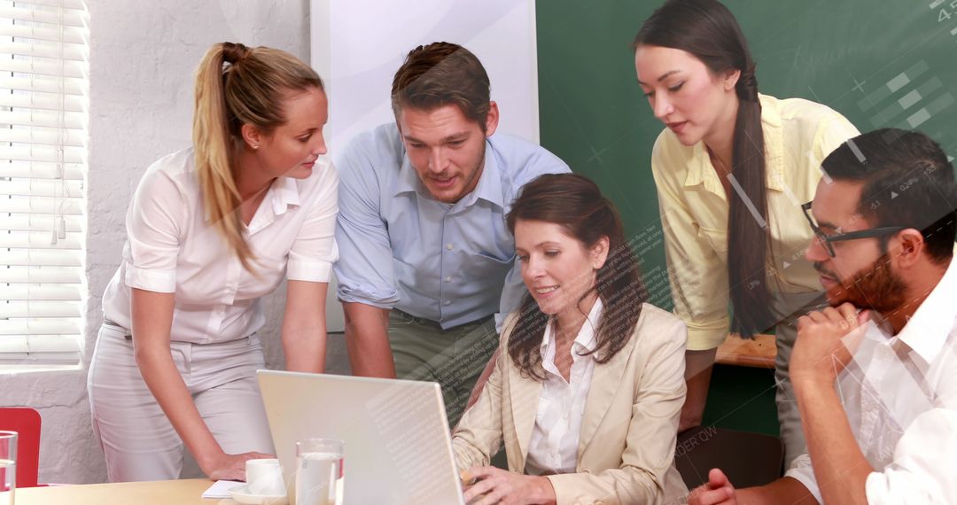 Diverse Team Collaborating on Project Using Laptop in Office Meeting - Free Images, Stock Photos and Pictures on Pikwizard.com