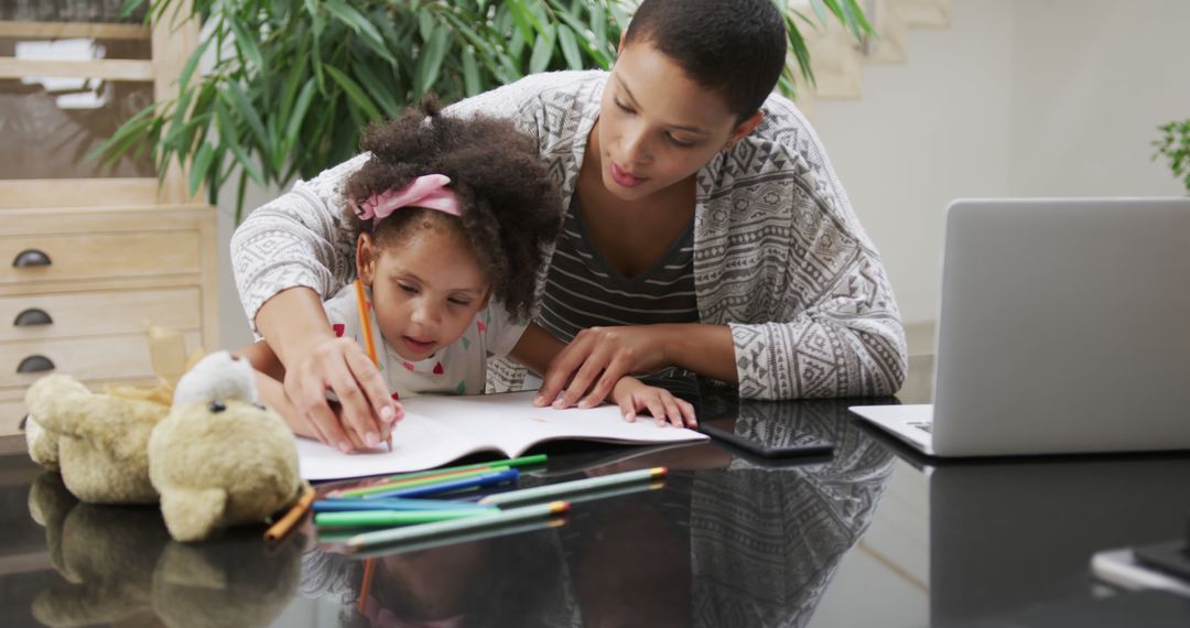 Mother Teaching Daughter with Homework at Home - Free Images, Stock Photos and Pictures on Pikwizard.com