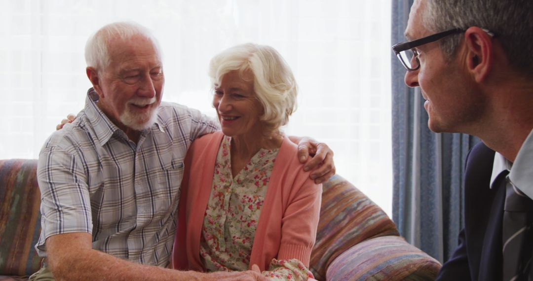 Senior Couple Discussing Financial Planning at Home with Advisor