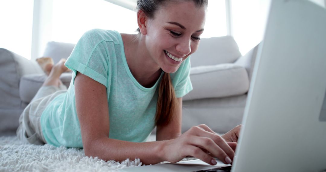 Smiling Woman Enjoying Laptop Relaxed at Home - Free Images, Stock Photos and Pictures on Pikwizard.com