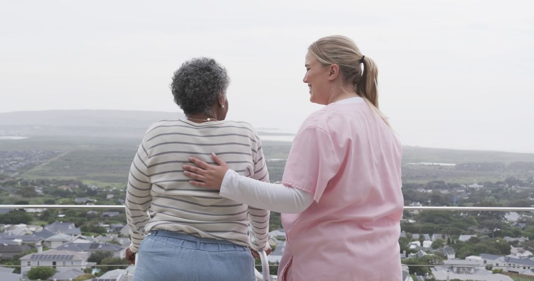 Caregiver Comforting Elderly Woman on Balcony with Scenic View - Free Images, Stock Photos and Pictures on Pikwizard.com