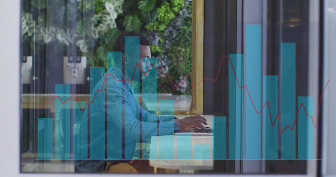 Focused Man in Denim Typing Amid Digital Charts Transparency