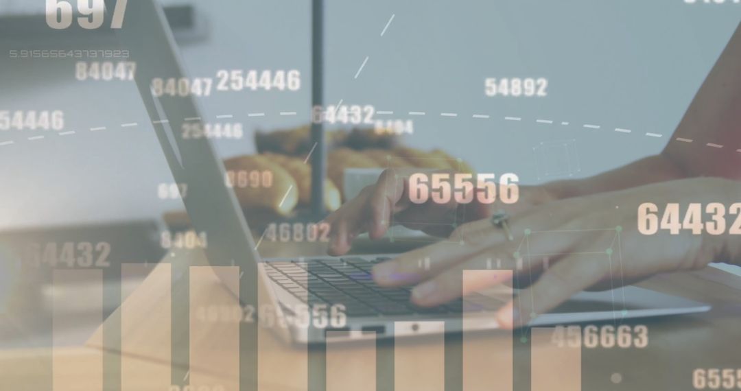 Hands Typing on Laptop with Overlay of Graphs and Data