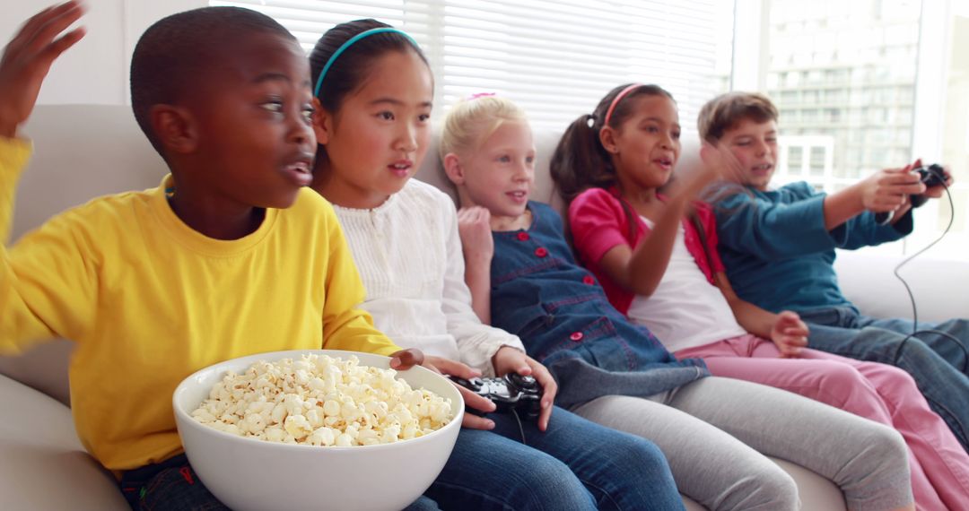 Diverse Group of Children Playing Video Games Together on Couch - Free Images, Stock Photos and Pictures on Pikwizard.com