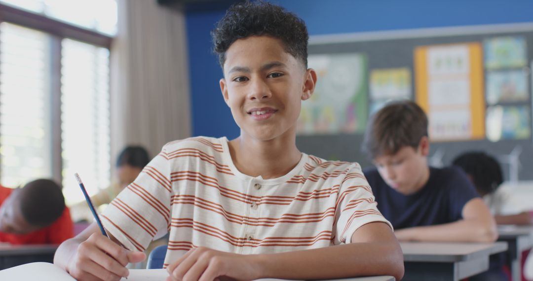 Confident Student Writing in Classroom Surrounded by Peers