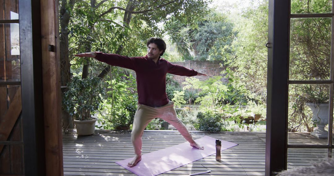 Biracial man practicing yoga standing on porch in garden - Free Images, Stock Photos and Pictures on Pikwizard.com
