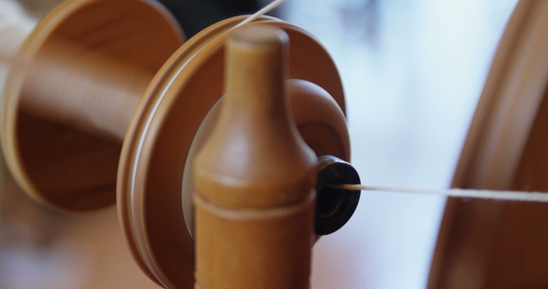 Close-Up of Wooden Spinning Wheel with Thread in Motion - Free Images, Stock Photos and Pictures on Pikwizard.com