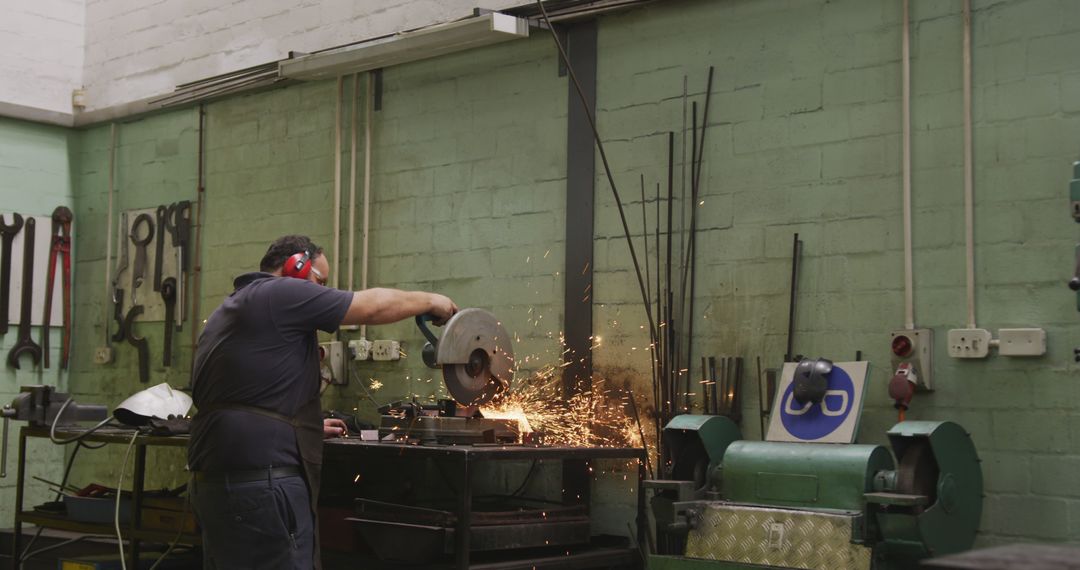 Engineer Using Angle Grinder Creating Sparks in Workshop - Free Images, Stock Photos and Pictures on Pikwizard.com