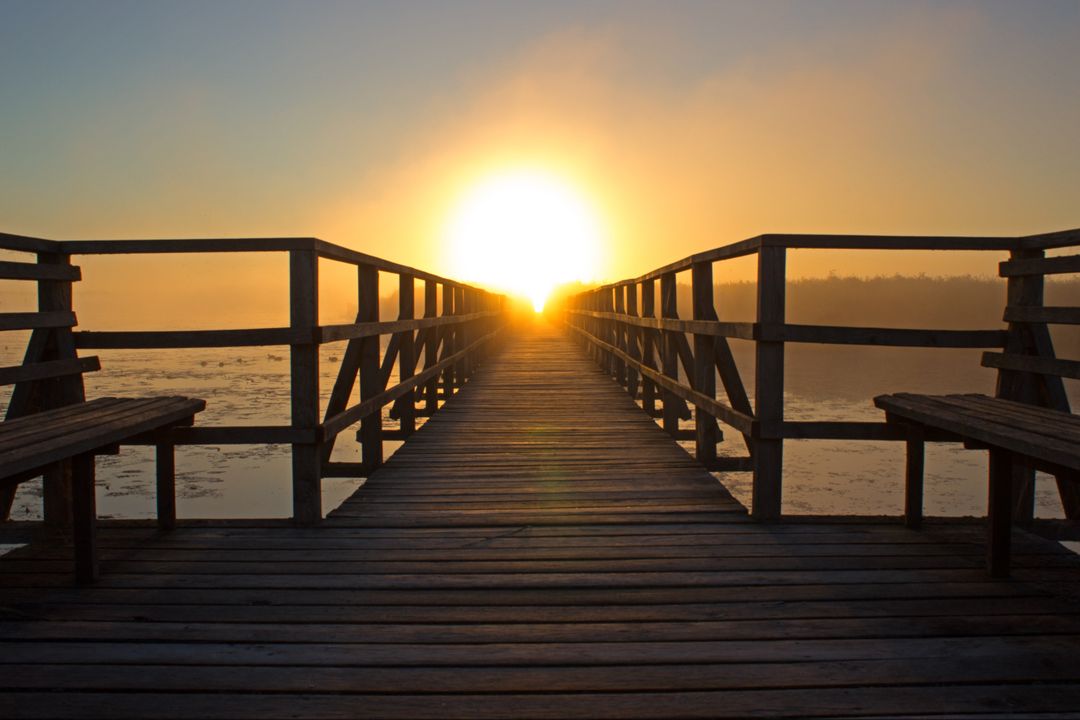 Serene Sunrise at Wooden Pier Over Calm Lake - Free Images, Stock Photos and Pictures on Pikwizard.com