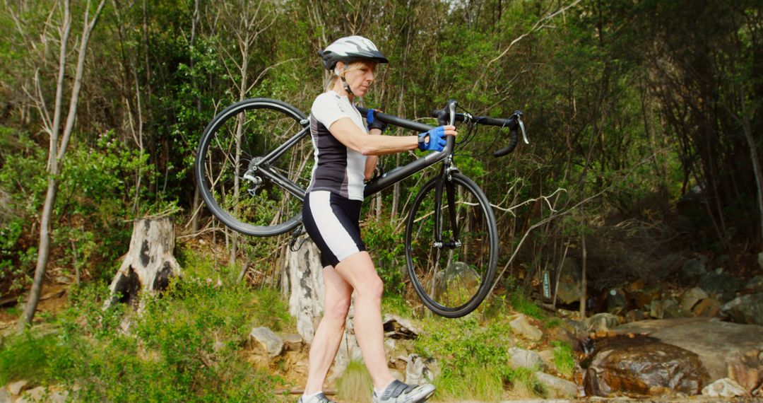 Female Cyclist Carrying Bicycle through Forest - Free Images, Stock Photos and Pictures on Pikwizard.com