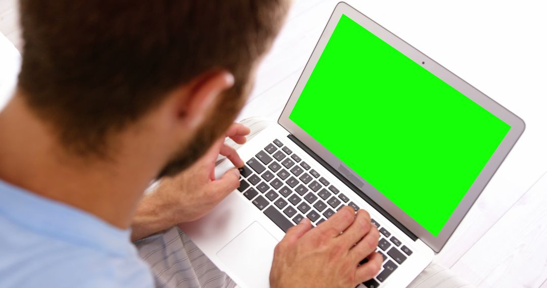 Person Using Laptop with Green Screen for Mockup and Editing - Free Images, Stock Photos and Pictures on Pikwizard.com