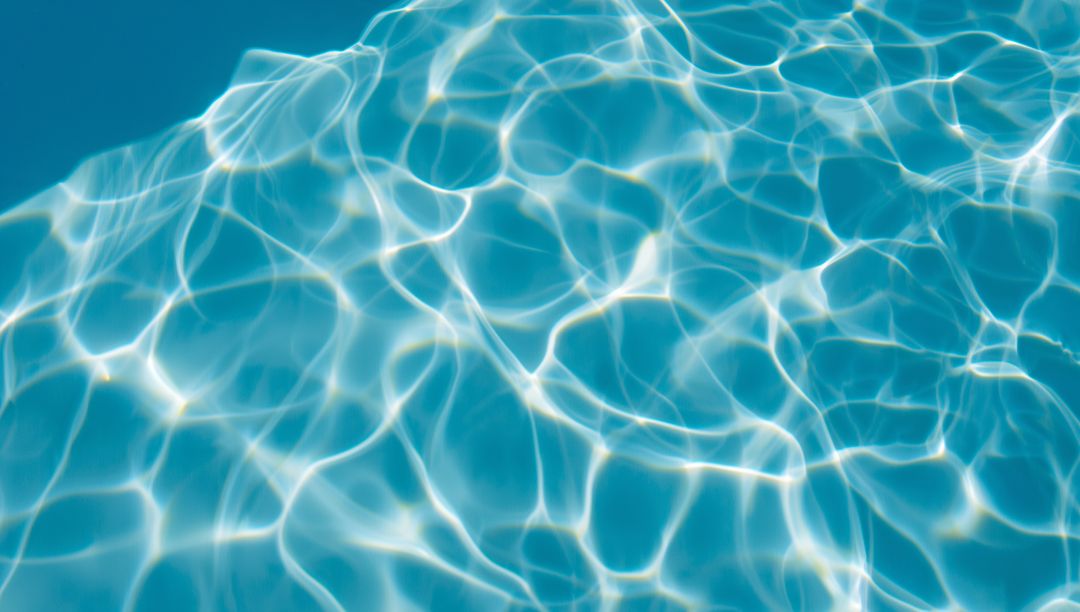 Rippling Clear Blue Water with Light Patterns