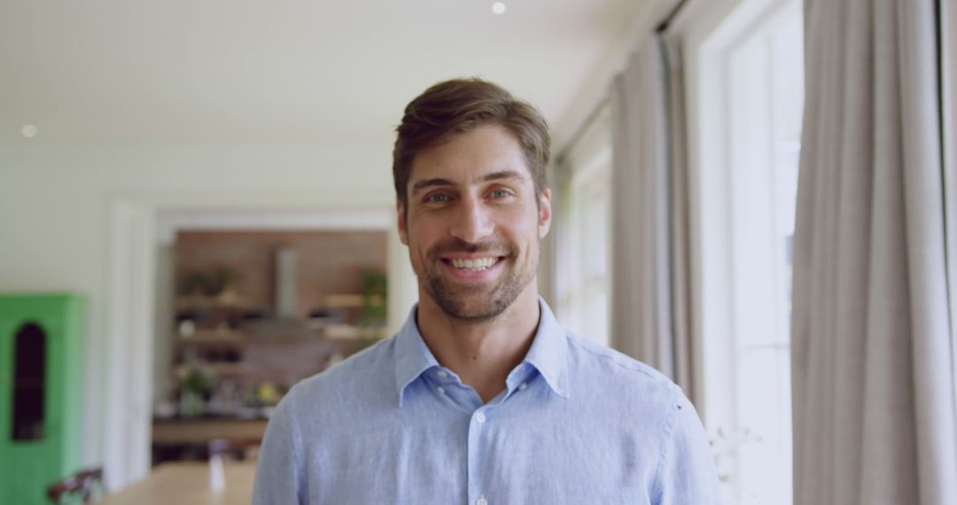 Smiling Man in Casual Shirt Standing in Modern Home Interior - Free Images, Stock Photos and Pictures on Pikwizard.com