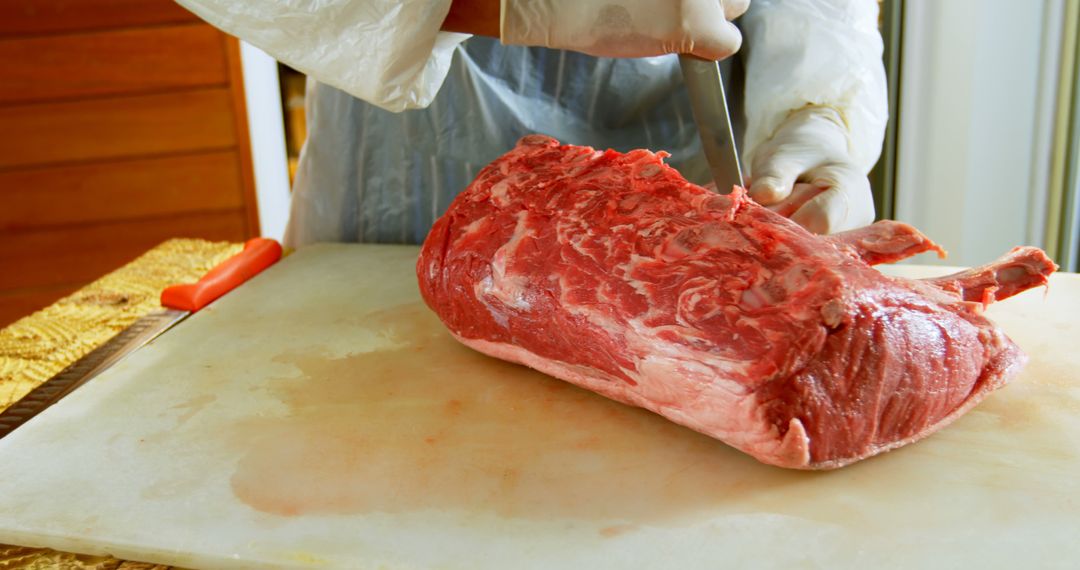 Butcher preparing fresh meat on cutting board - Free Images, Stock Photos and Pictures on Pikwizard.com