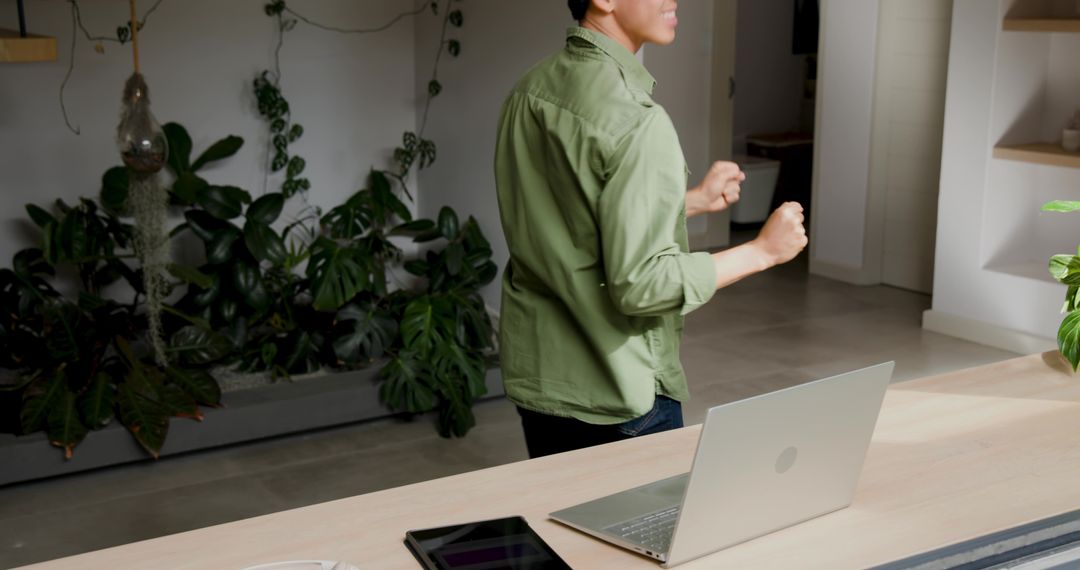 Professional Gesturing in Modern Office Near Desk with Laptop