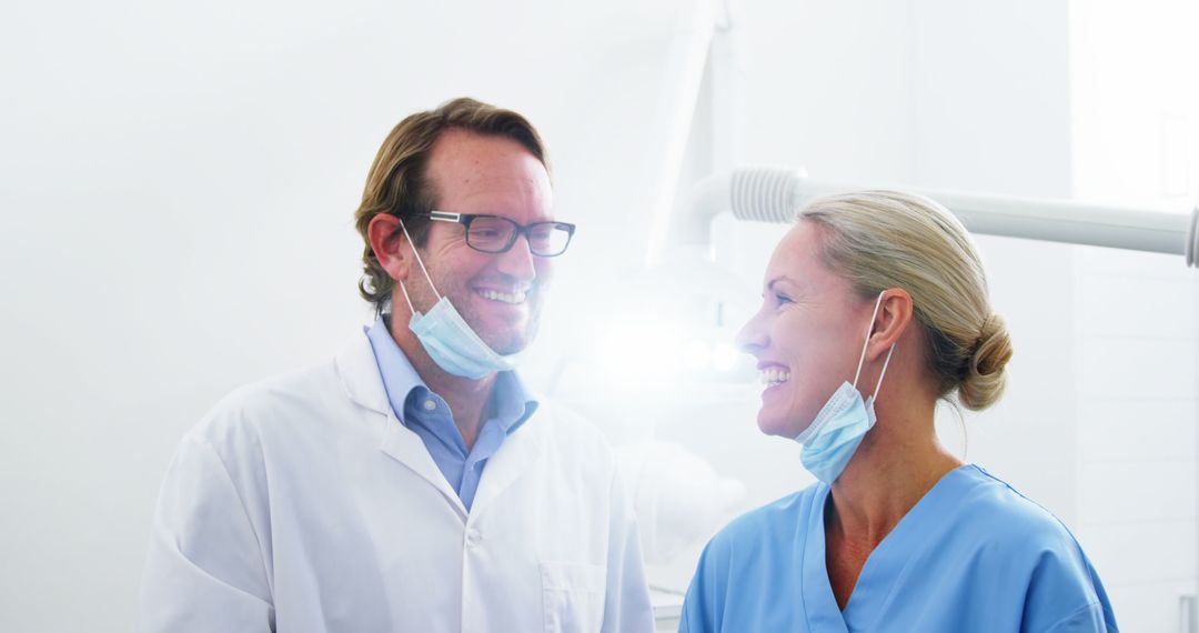 Smiling dentists talking while working in dental clinic - Free Images, Stock Photos and Pictures on Pikwizard.com