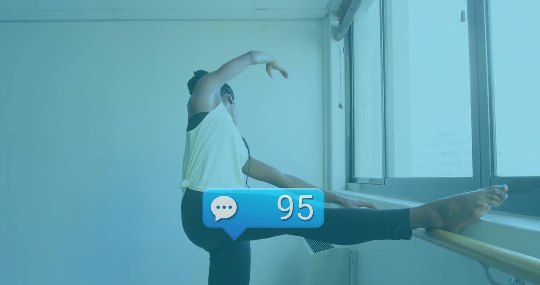 Ballet Dancer Stretching by Barre in Urban Studio