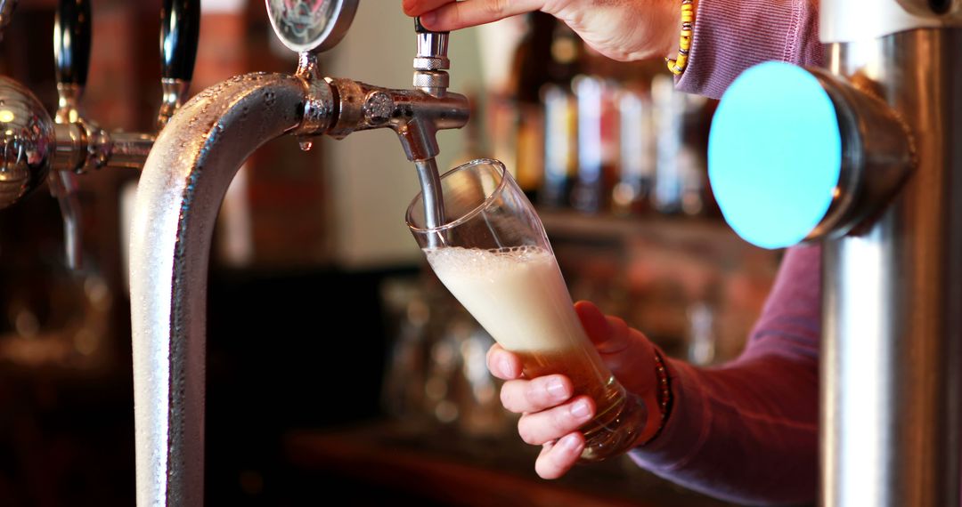 Bartender Pouring Draft Beer in Glass at Pub - Free Images, Stock Photos and Pictures on Pikwizard.com