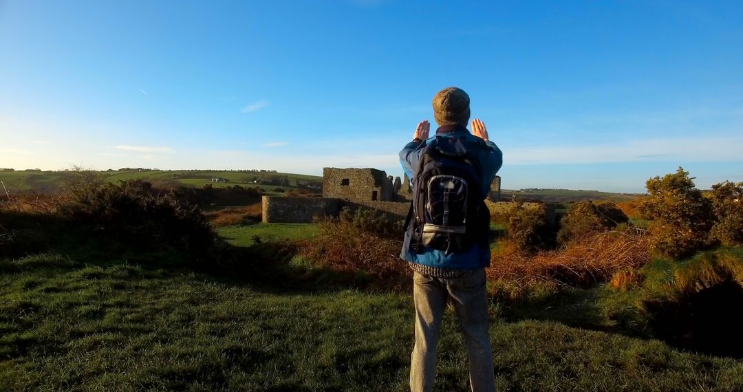 Man Photographing Remote Castle on Scenic Countryside Day
