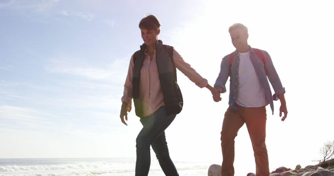 Older Couple Holding Hands Walking on Beach During Sunset - Free Images, Stock Photos and Pictures on Pikwizard.com