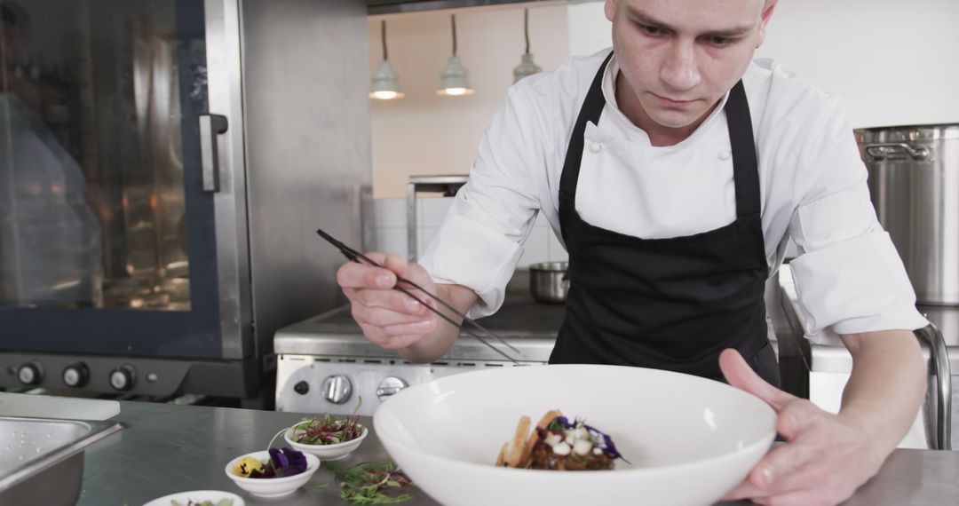 Focused Chef Plating Gourmet Dish in Professional Kitchen - Free Images, Stock Photos and Pictures on Pikwizard.com