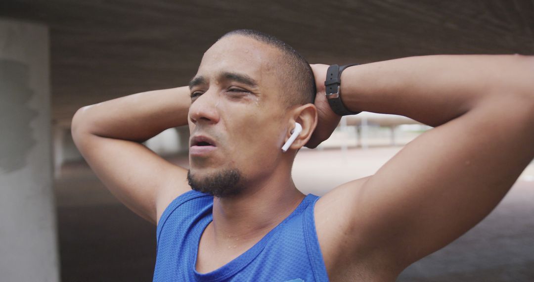 Tired Male Runner Taking a Breather with Wireless Earbuds - Free Images, Stock Photos and Pictures on Pikwizard.com