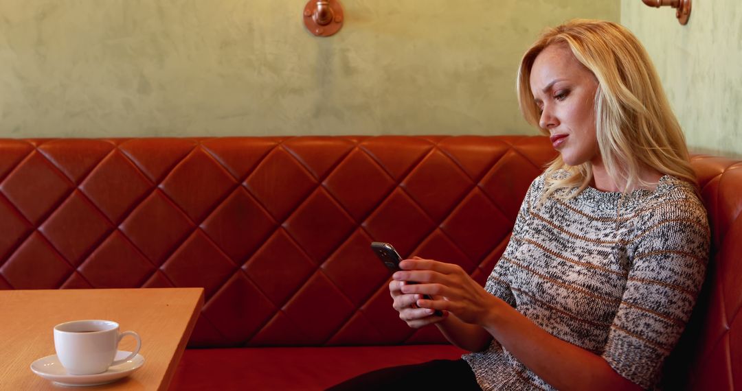 Woman Relaxing in Cafe While Using Smartphone - Free Images, Stock Photos and Pictures on Pikwizard.com