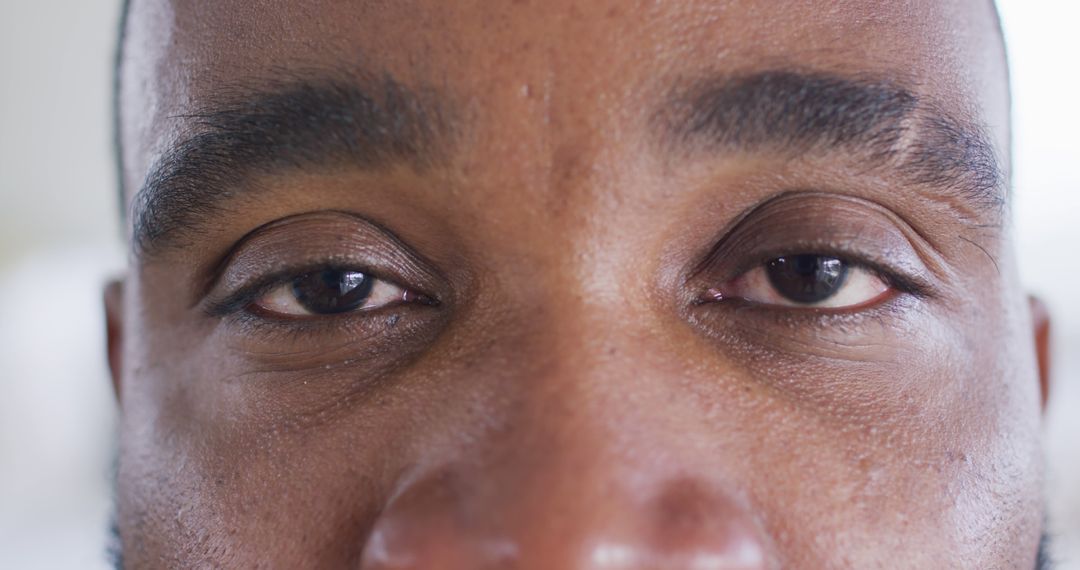 Close up portrait of opening eyes of african american man looking to camera, in slow motion - Free Images, Stock Photos and Pictures on Pikwizard.com