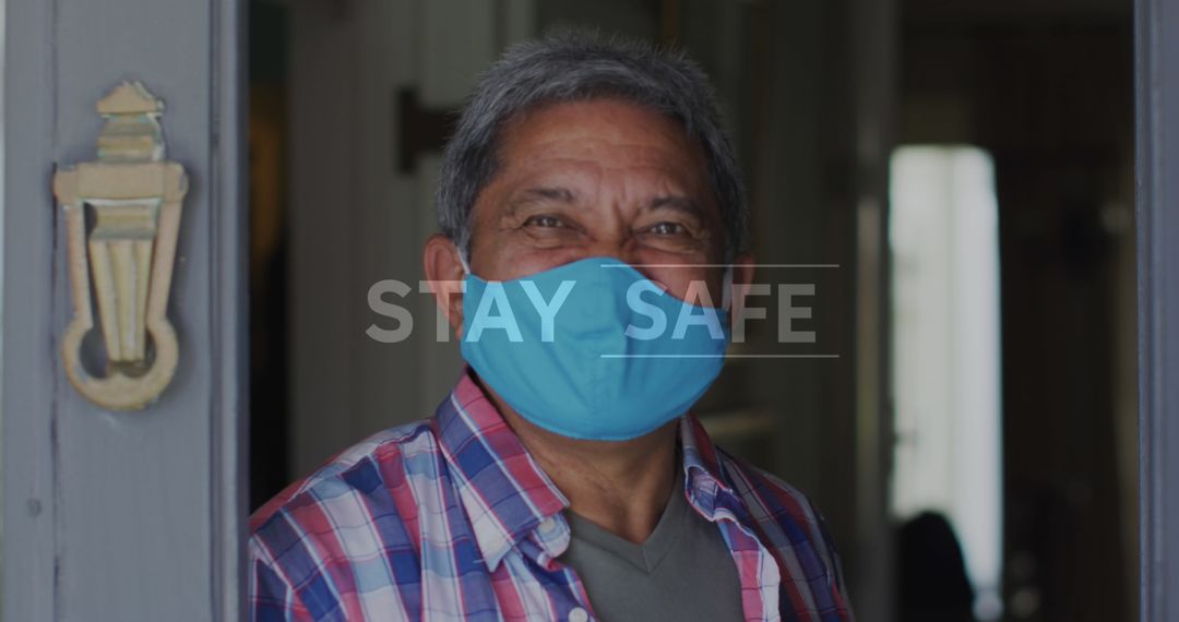 Older Man in Checkered Shirt Smiling with Mask at Doorway