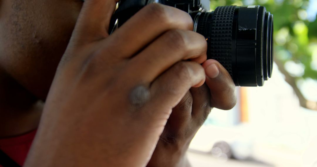 Close-Up of Photographer Holding Camera and Focusing Lens - Free Images, Stock Photos and Pictures on Pikwizard.com