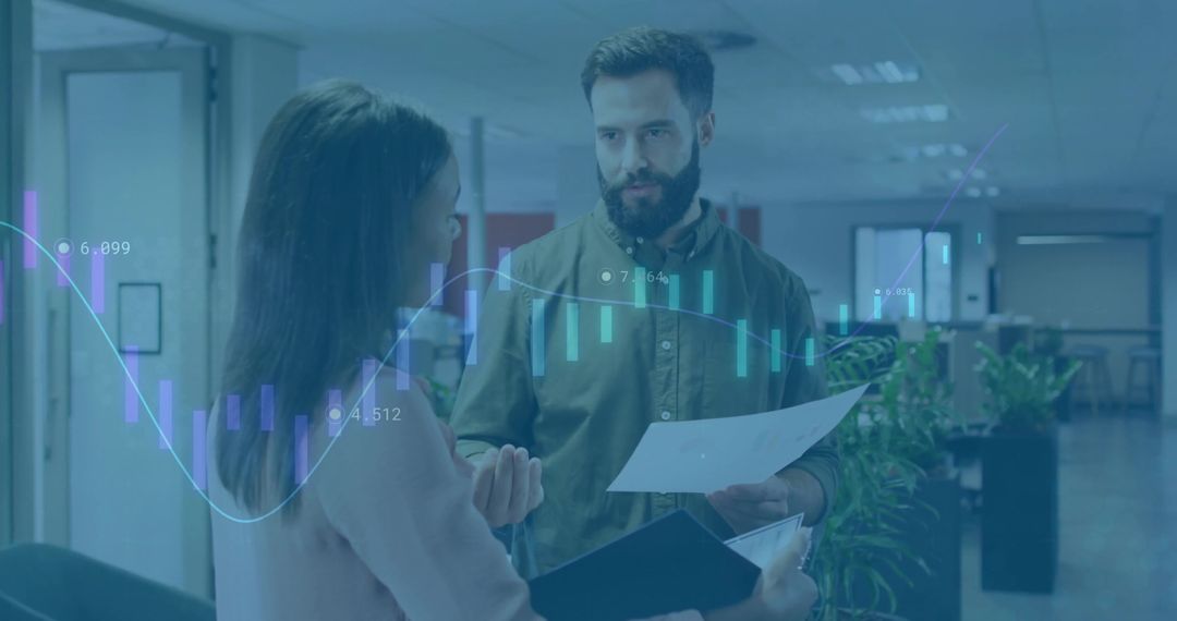 Colleagues Discussing Financial Data in Office Corridor