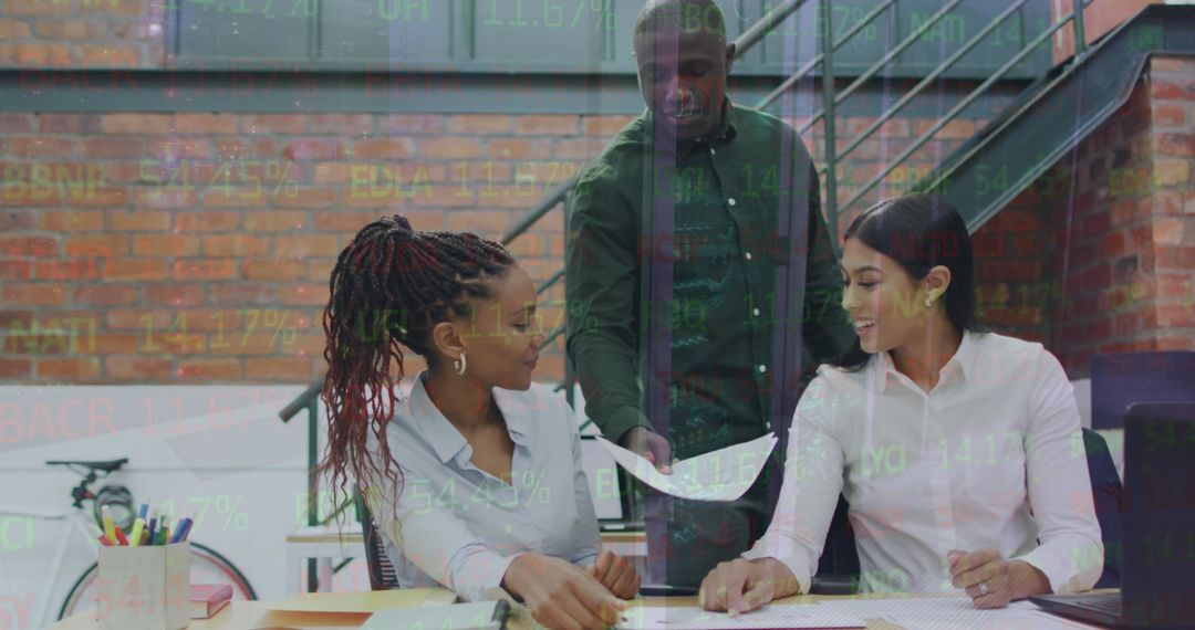Coworkers Analyzing Financial Data in Modern Office Environment