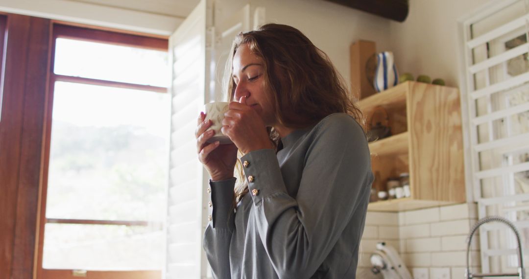 Woman Enjoying Morning Coffee in Cozy Kitchen Setting - Free Images, Stock Photos and Pictures on Pikwizard.com