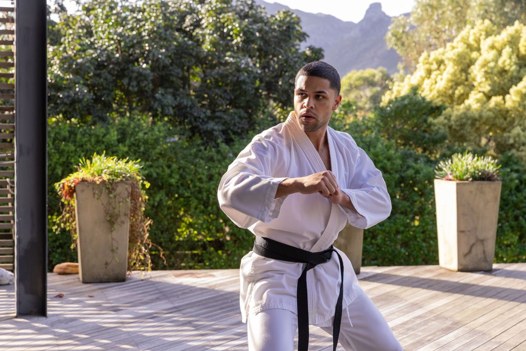 African American Martial Artist Training Outside in White Gi and Black Belt