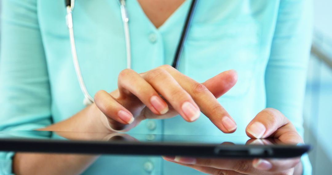 Doctor Using Digital Tablet in Modern Medical Environment - Free Images, Stock Photos and Pictures on Pikwizard.com