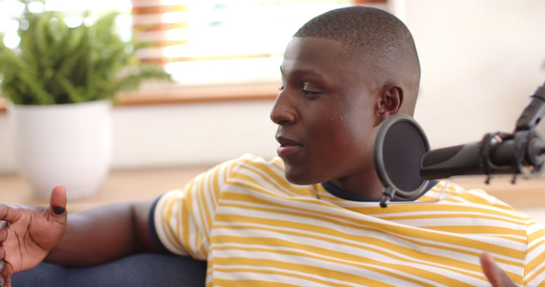 Podcaster Communicating Insights in Relaxed Studio Setting