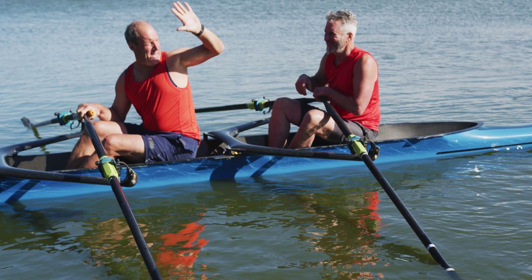 Two senior caucasian men in rowing boat high fiving - Free Images, Stock Photos and Pictures on Pikwizard.com