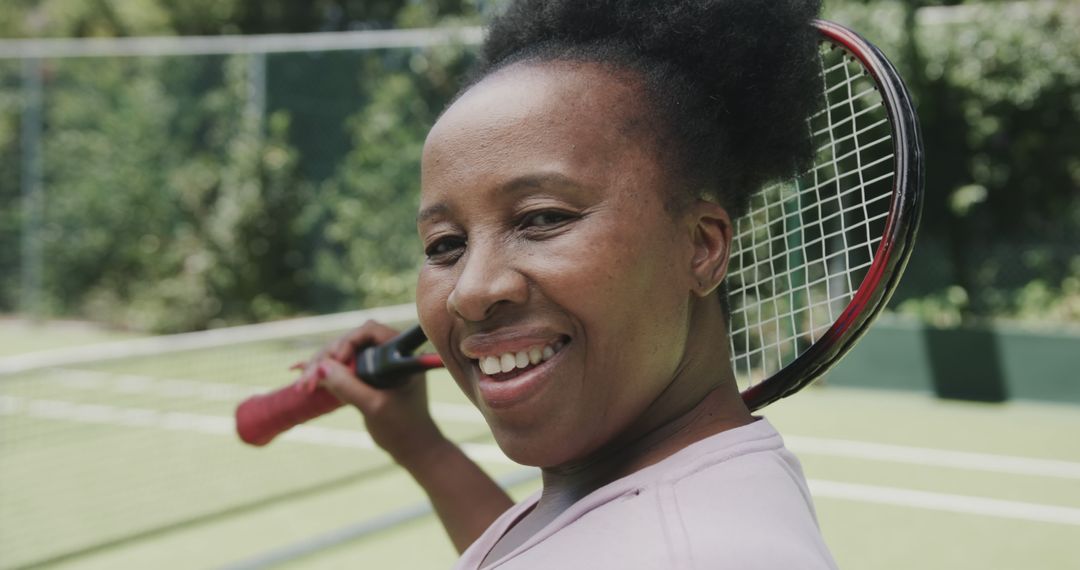 Smiling Female Tennis Player on Outdoor Court - Free Images, Stock Photos and Pictures on Pikwizard.com