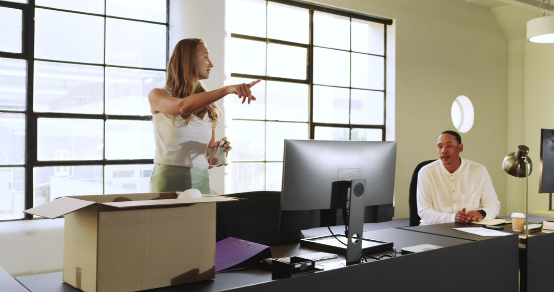 Woman Setting Up Modern Office Workspace with Focused Attention