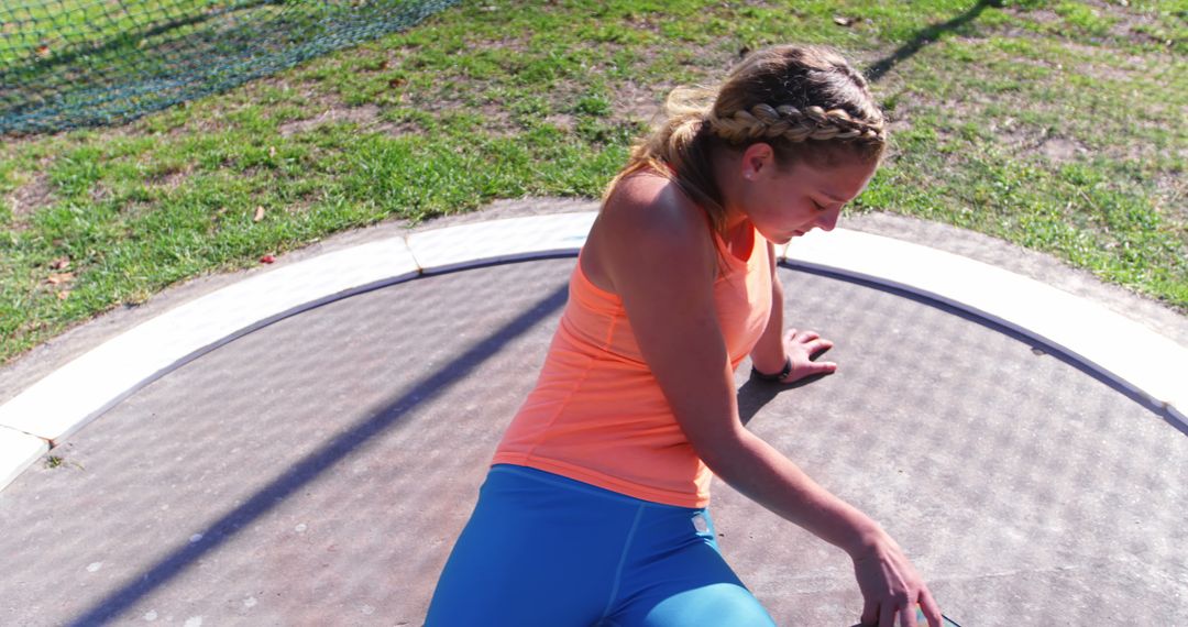 Female Athlete Preparing to Train for Discus Throw on Sunny Day - Free Images, Stock Photos and Pictures on Pikwizard.com