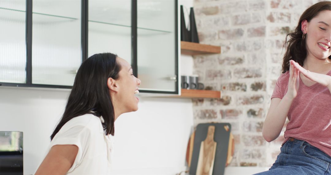 Multiracial Friends Celebrating Engagement in Sunlit Kitchen