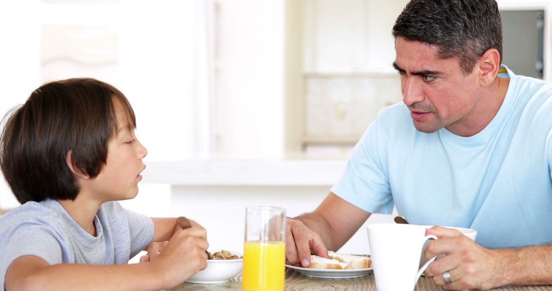 Father and Son Sharing Breakfast at Home - Free Images, Stock Photos and Pictures on Pikwizard.com